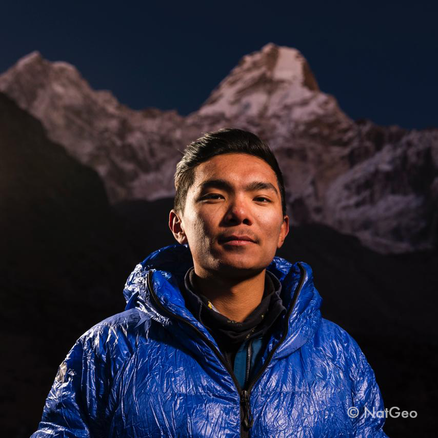 Climber sitting on mountain peak